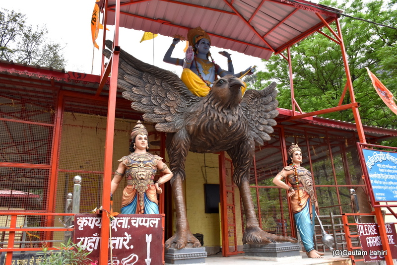 At the Garud Chatti Temple, visitors are required to pass beneath the bird, walking between its legs, to reach the shrine in Rishikesh. Lord Vishnu sits on top by gautam lahiri