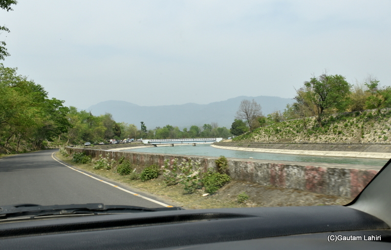 Bounded by rows of dense forest, the Chilla canal is skirted by a straight ribbon of a road, Rishikesh by gautam lahiri