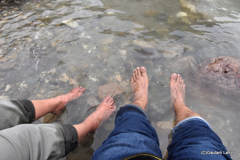 Feeling the cool Ganges water at Rishikesh by Gautam Lahiri