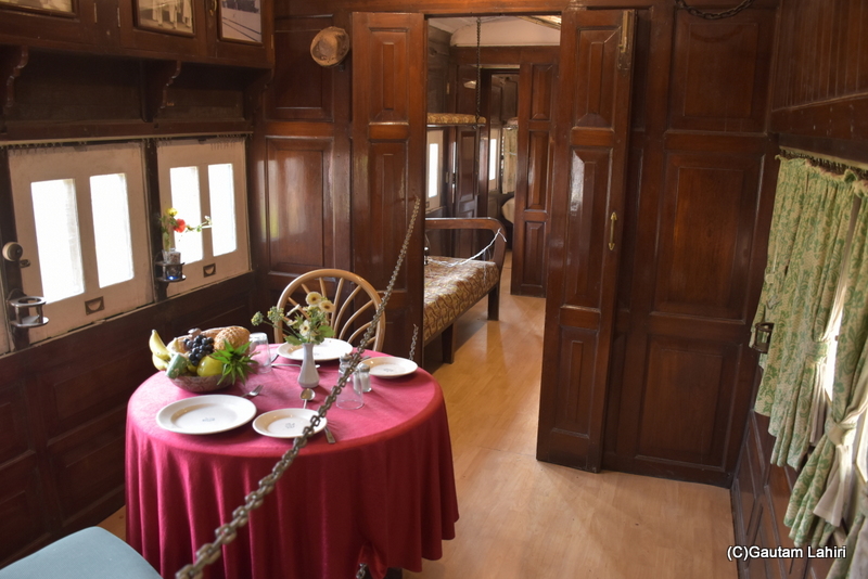 The wooden dining room area inside the Gondal carriage at Orchard Palace, Gujarat by gautam lahiri