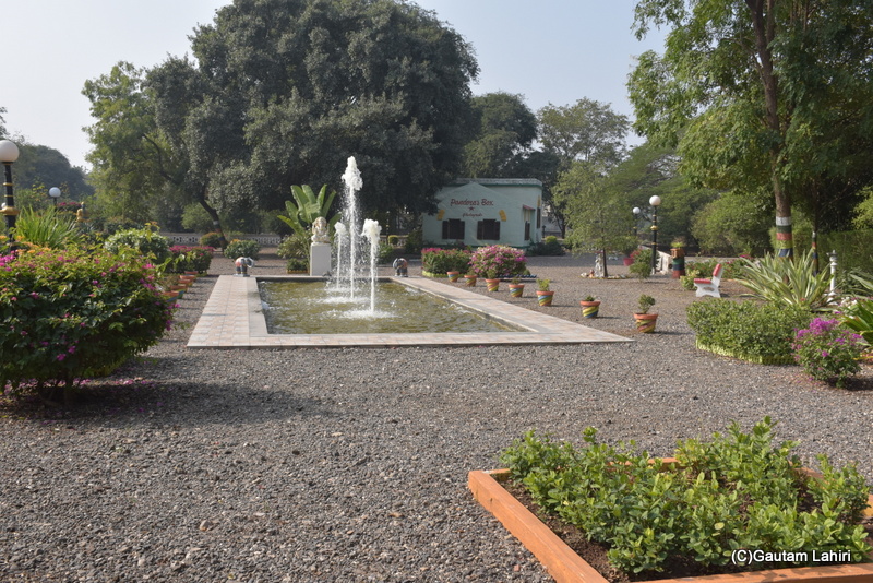 An old British styled 1900 edifice was pepping through the trees just beyond a tri fountain that jettisoned columns of water adding to the beauty at Orchard Palace by gautam lahiri