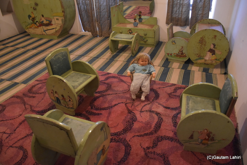 In the 18th century, a child's room at the Naulakha Palace in Gondal featured a doll seated on a small chair, surrounded by intriguing furniture and paintings by gautam lahiri