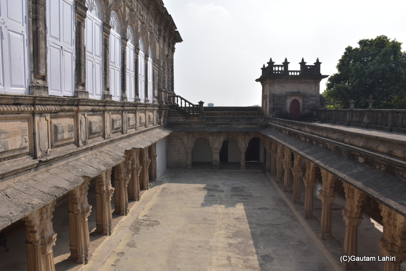 Modern windows set within the old architectural frames shield the interiors of the Palace from the elements. Small minarets gaze out from a distant corner towards the sky, echoing the royal tales of Naulakha Palace in Gondal, Gujarat by gautam lahiri