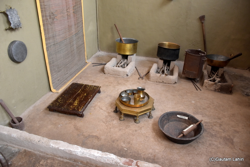 This appeared to be a faithful reproduction of the kitchen from that era. A brass stool accompanied by copper vessels for water and food, two mud-brick kilns, an iron hand grinder, and a wheat bread roller completed the display for visitors at Naulakha Palace, Gondal by gautam lahiri
